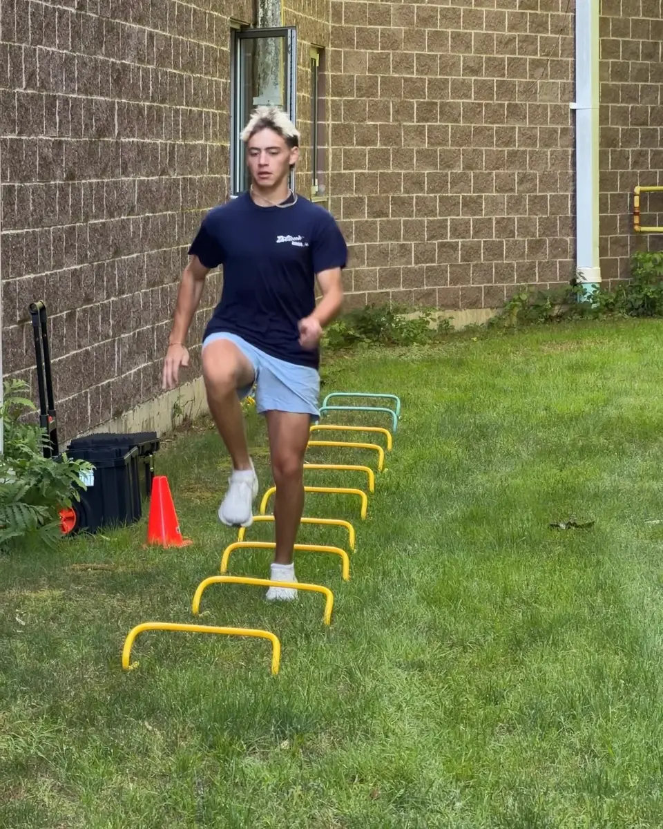 Athlete completing a coached sprint session during the summer program